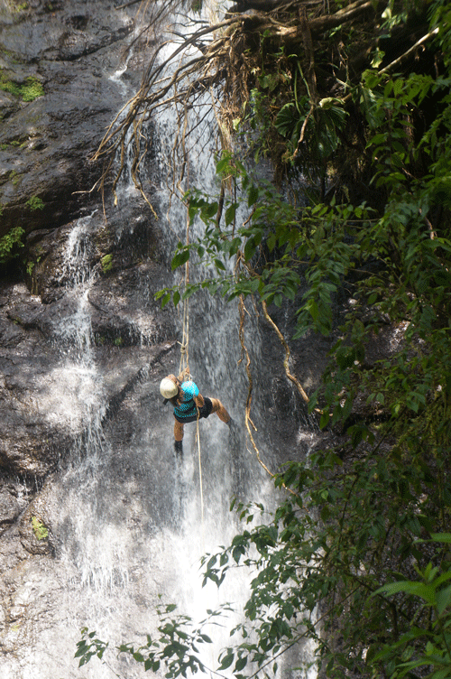 Shayley J. rappels a waterfall. 