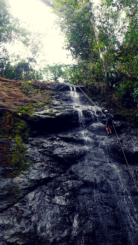 Instructor rappelling down a 80-foot waterfall