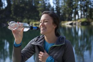 Women drinking water from a filtered bottle